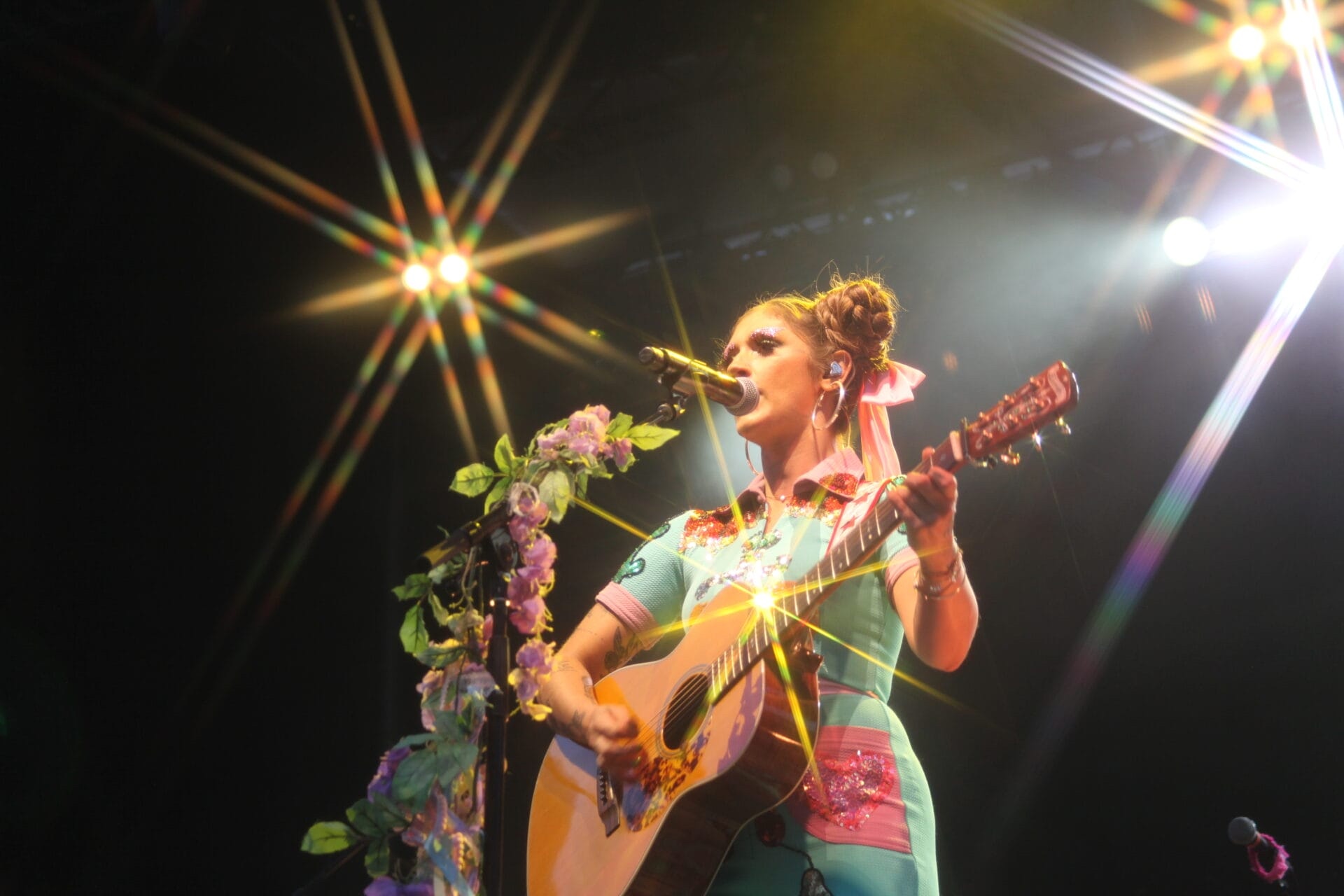 Woman playing guitar on stage